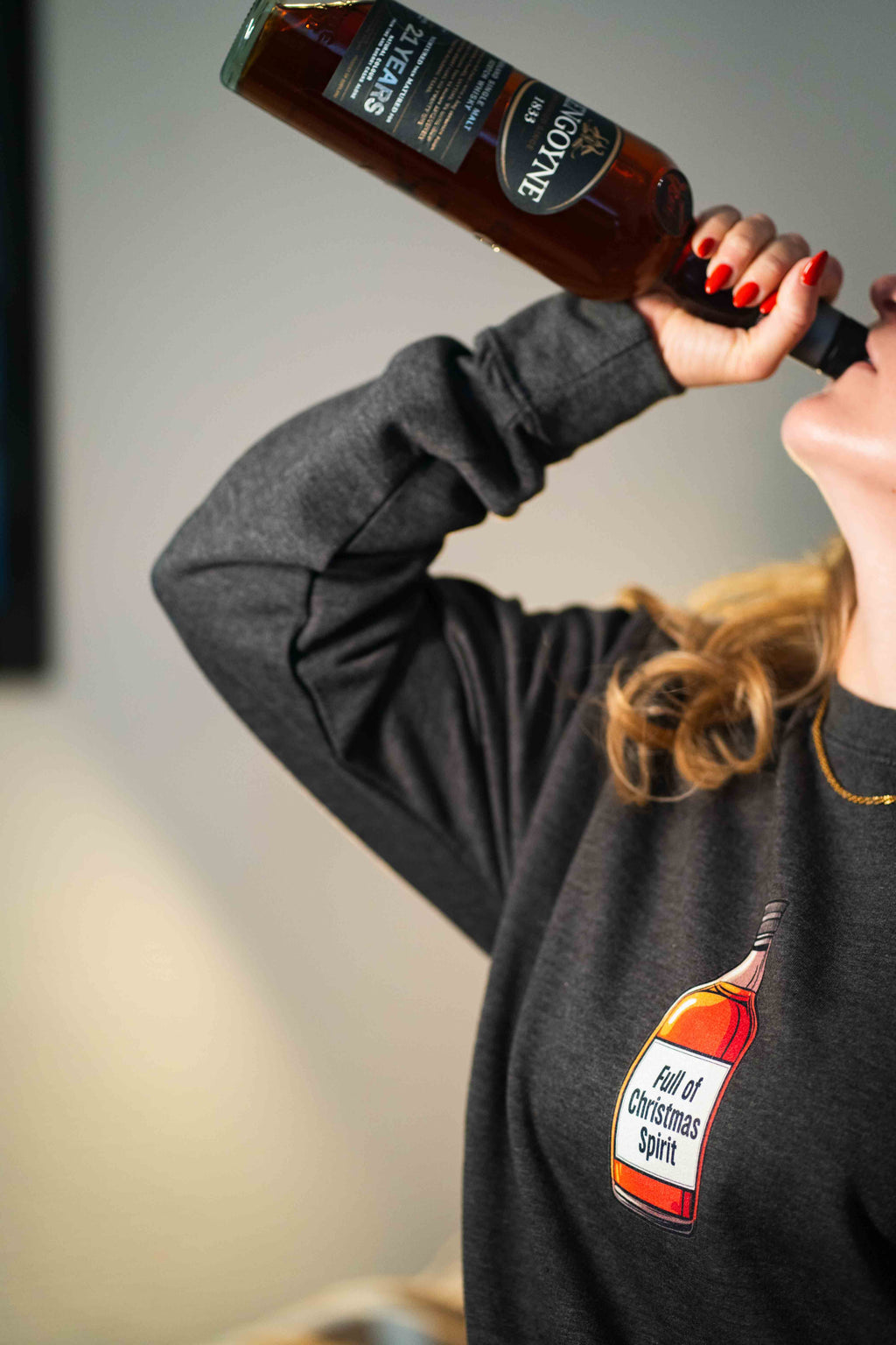 drinking from the bottle in a christmas jumper