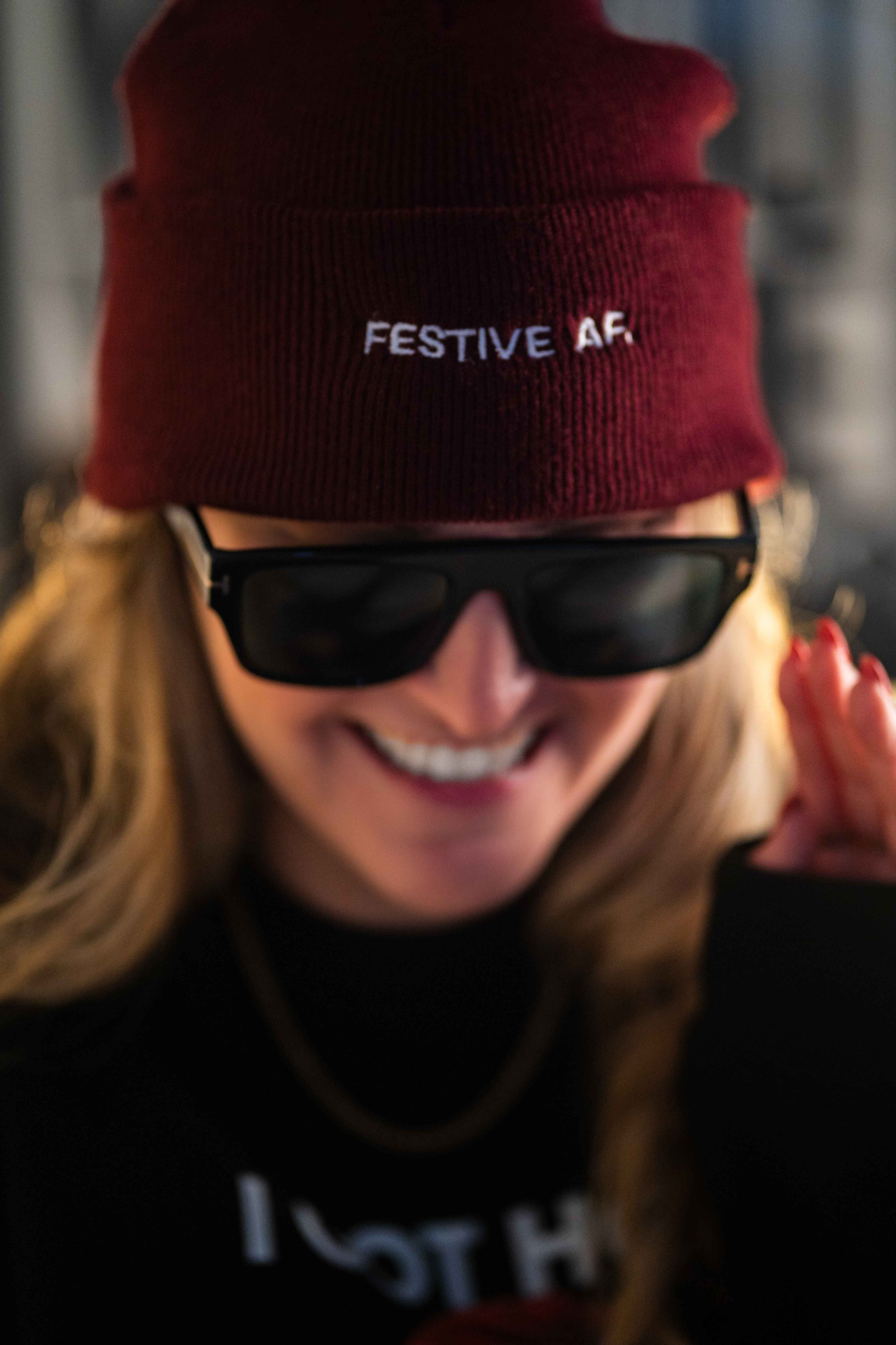 Girl wearing festive af christmas beanie